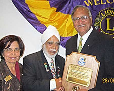 The President of The Lions Club of Osterley (London), Mr. Jagjit Singh Gill, awarding Rahi Bains with the "Melvin Jojnes Fellow" award in June 2013.